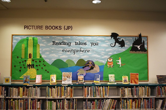 This bulletin board at Patrick Henry Library displays the summer reading program theme: “Reading takes you everywhere.”