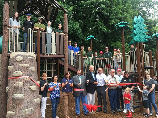 From left: Cindy Walsh, Director of Resource Management; Isabel Villarroel, Project Manager; Aimee Vosper, Deputy Director; Mike Thompson, Park Authority Board; State Sen. David Marsden (D-37); Bill McCabe, Legislative Aide; Mike McCaffrey, Park Manager; and Michelle Alexander, Assistant Manager with volunteers and park visitors cutting the ribbon for the new playground.