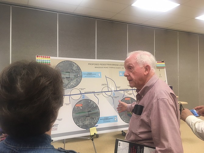 Long-time resident Bill Brennan looks at the plans for the intersection near his house.