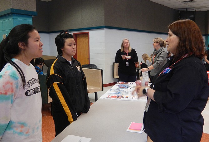 From left: Sisters Mia and Sara Masaki listen to Luciana Barletta with AMC Worldgate 9.