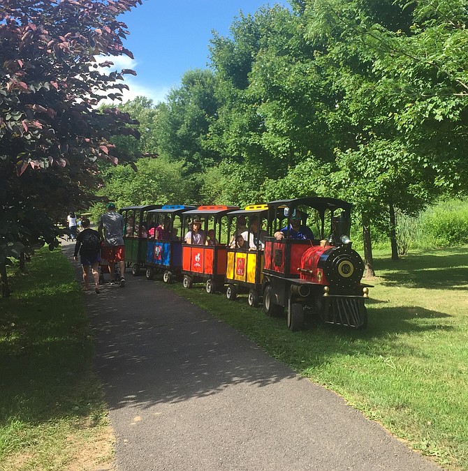 The Trackless Train rolls through the park. Friends of Clemyjontri funded the train and a “train station” which will open in the future.
