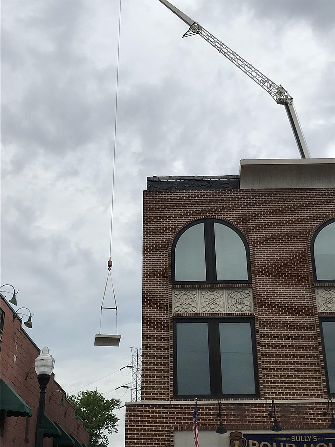 KGS Construction Services begins to hoist the remaining concrete rooftop cornices off the Stout and Teague Building after an entire row of individual stones, each weighing 3,000+ pounds, crashed into a popular dining site on Saturday, June 8. 