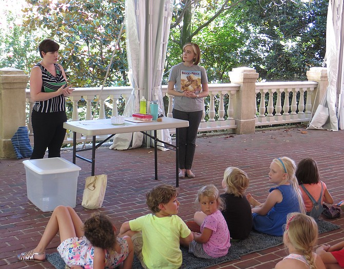 Allison Kelley (left) and Diana Price read to local children at “Read, See, Do.”