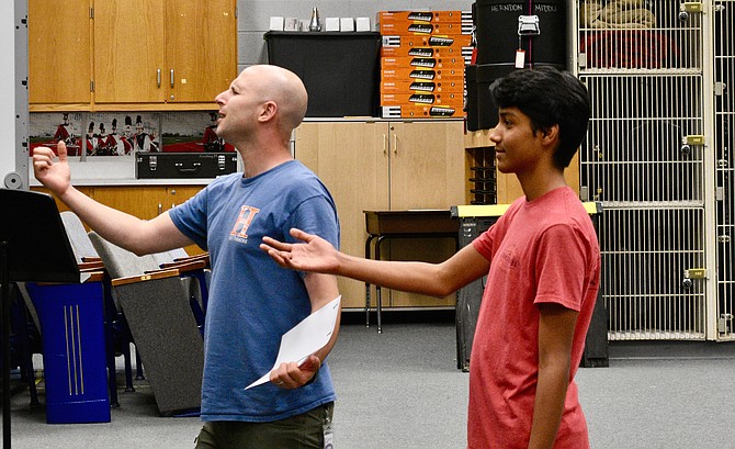 Director Raphael Schklowsky coaches Herndon High's Ankit Poudel on his lead role as Prince Eric.
