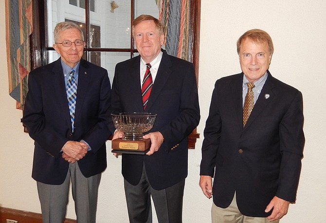 Two mayors and a city manager: From left, John Mason and David Meyer present Bob Sisson (center) with the prestigious Fairfax Award.