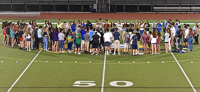 Classmates and peers participate in a vigil at Coffey Stadium in  Conner McGowan’s honor, several nights after his death. 