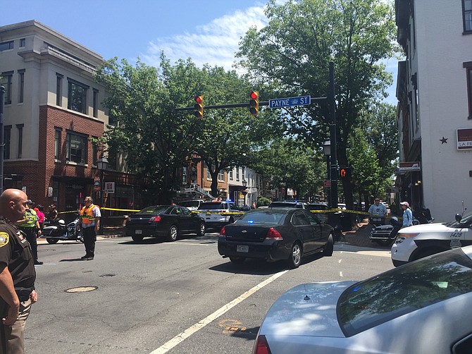 Sheriff Deputy Joseph Runquist maintains a perimeter around the murder scene on King Street.
