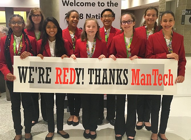 City of Fairfax FCCLA members, from both Lanier Middle and Fairfax High schools, with a banner thanking their sponsor, ManTech. (From left) are Kayleigh Williams, Juli Luckabaugh, Miranda Cespedes, Naomi Daniels, Riley Sarber, Yale Kim, Emily Sarber, Hope Peters and Hana Ismail. (Not pictured: Diego Santiago).
