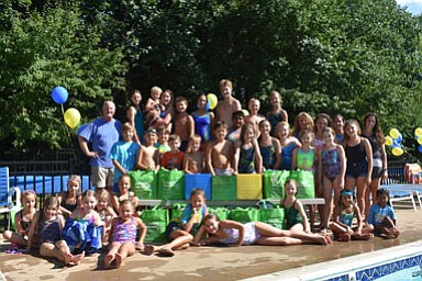 The Shouse Village swim team collected more than 300 pounds of food donations for A Simple Gesture. (Standing, left: Bob Park, right: Melissa Carey)