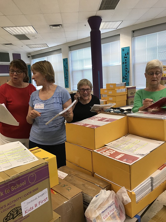 Kids R First (KRF) volunteers Valerie Warriner, Martha Chamberlin, Patty Gehring, and Susan Ungerer, CEO and Founder of KRF, pack up donated school supplies for needy public school children in participating Fairfax and Loudoun County Schools.