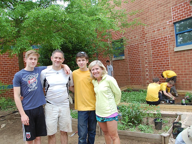 From left: Ethan Himes, dad Michael Himes, Caleb Himes, and Kent Gardens Elementary School Principal Holly McGuigan at the Monarch Waystation at the school.