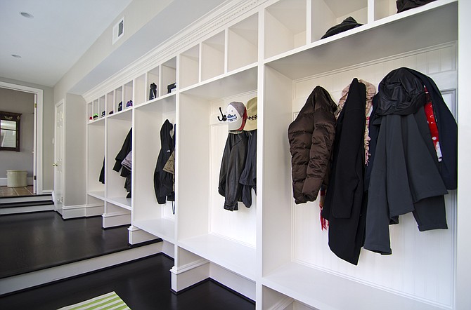 This mudroom designed by Allie Mann of Case Design/Remodeling features a cubbie for each family member. 
