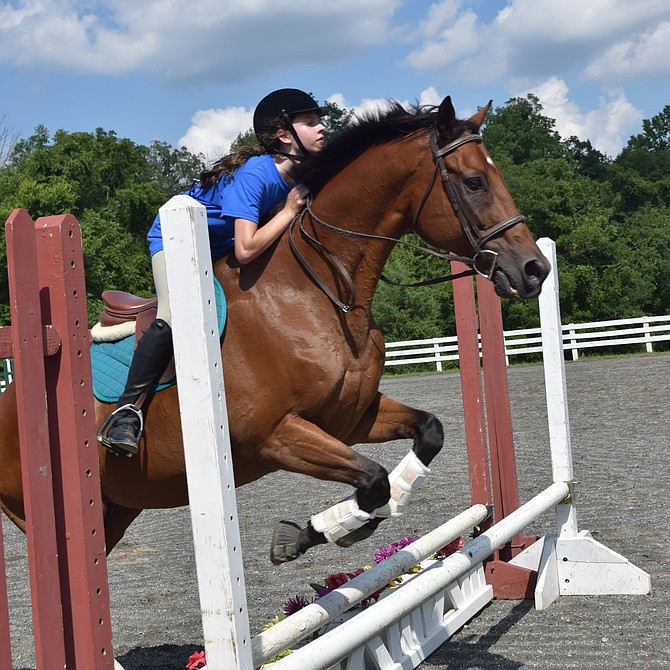 Helen Lyons, of the Hampton Horsefeathers 4-H Club, and her horse Chance take part in Show Jumping during the 2018 Fairfax County 70th Annual 4-H Fair and Carnival held at Frying Pan Park in Herndon. 