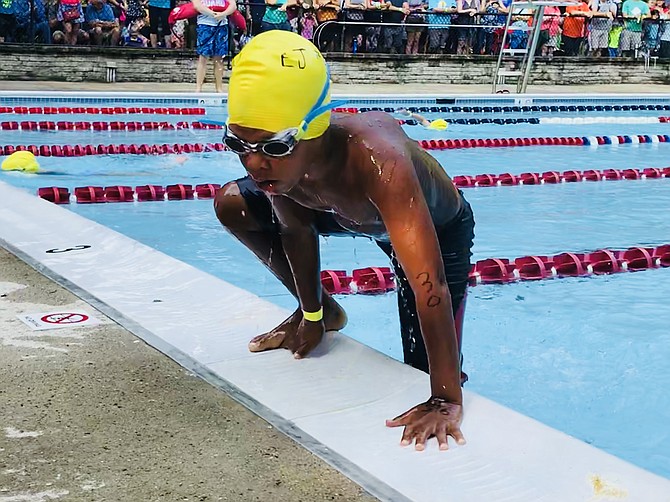 #30 in the 6-8-year-old division of the Reston Kid's Triathlon leaves the pool and gets ready to run to his bike, get dressed, and speed off for the second phase of the tri.
