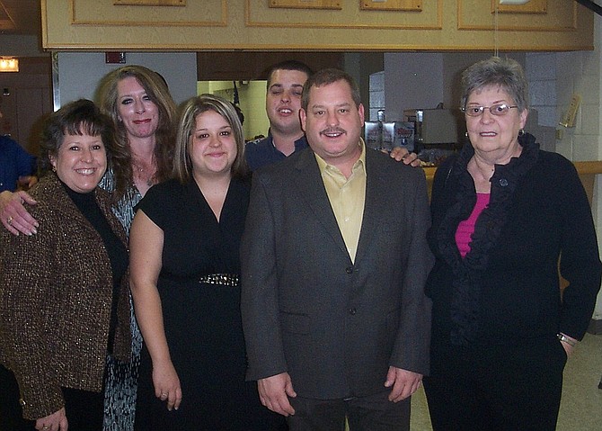 Dee Schmidt (at far right) with family members (from left) daughters Ellie Schmidt and Bridget Shepard, granddaughter Jessica Thornton, grandson Rick Schmidt Jr. and son Rick Schmidt.
