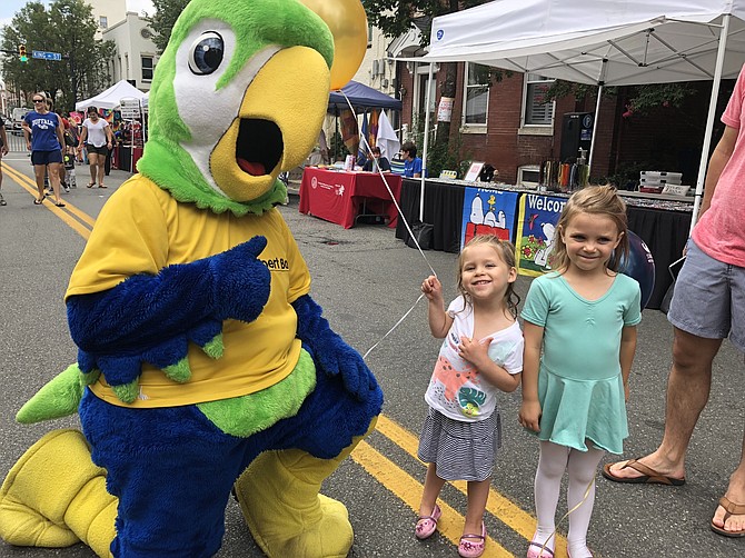 Sisters Kennedy and Camilla  Dorn pose for a photo with Burke & Herbert bank mascot Runyon.