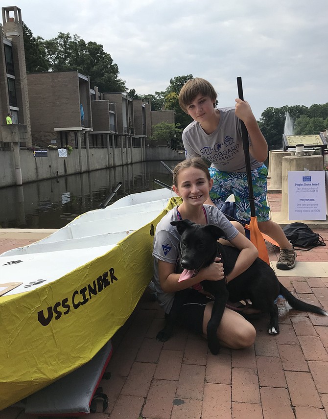 Pirates Lea Daniel, 11, from Great Falls and her brother, Quincey, 14, prepare to launch “USS Cinder” at the 2nd Annual Lake Anne Cardboard Boat Regatta held Saturday, Aug. 11. The team placed first in the Cadet Class with a time of 2:14.