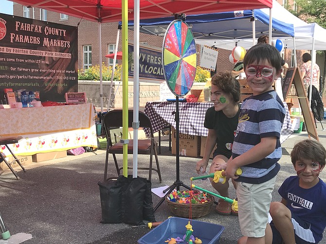 On Thursday, Aug. 9, during National Farmers Market Week, Emmet Drost, 7, from Herndon and his brother Sawyer, 5, try their skills at 'local fishing’ during the Fairfax County Park Authority Farmers Market in Historic Downtown Herndon.
