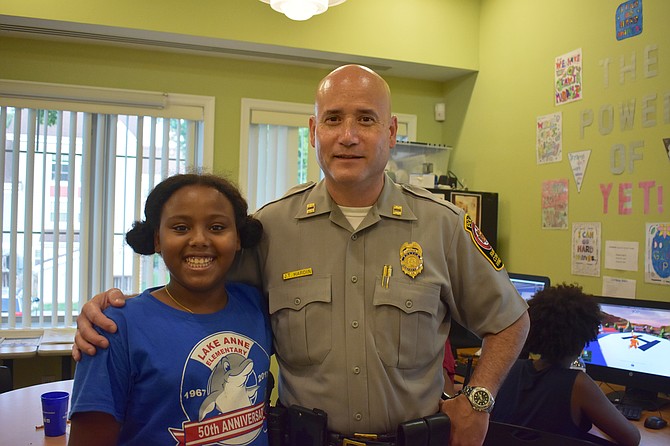 Ten-year-old Yumna Ahmed meets Captain Jack Hardin of the Reston District Police Station at her neighborhood’s National Night Out event Aug. 7.