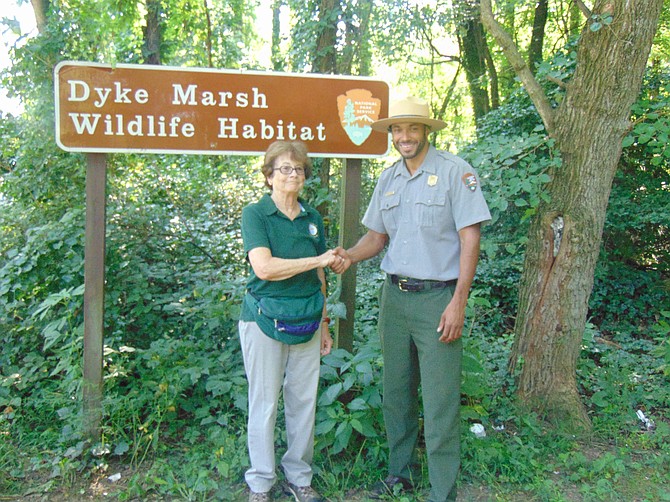 Commemorating the announced start of Dyke Marsh restoration are Dorothy McManus, board member, Friends of Dyke Marsh, and Chief of Staff of U.S. National Park Service Aaron Larocca at the entrance to Dyke Marsh Wildlife Preserve on Aug. 8.
