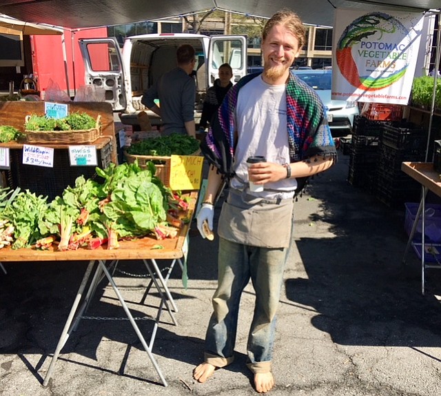 Michael Newcomb sells and plays guitar at Potomac Vegetables.