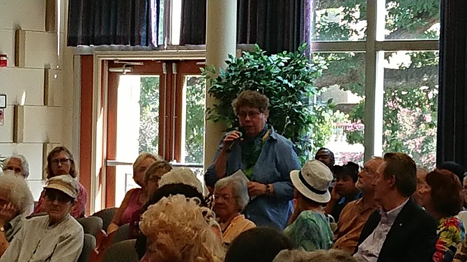 Laura Lawson asks a question regarding Virginia’s Real ID procedures during a community meeting with U.S. Sen. Tim Kaine Aug. 15 at The Hermitage Northern Virginia.