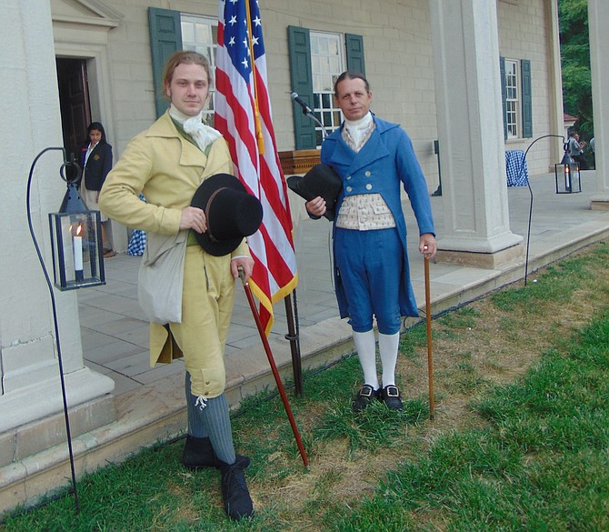 “Col. Tobias Lear” (right) and “George Washington Parke Custis” are official greeters at the annual  family night picnic on the grounds of President and Mrs. Washington’s estate on Sunday, Aug. 19. Approximately 2,000 area residents attended the event, which included food, music, and raffle drawings.
