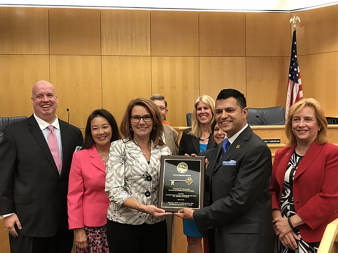 During the mid-August Herndon Town Council Public Hearing held in the Herndon Council Chambers, Mayor Lisa C. Merkel, Vice Mayor Jennifer K. Baker and Members of the Herndon Town Council presented the Key to the Town of Herndon to Runnymede official, Chancellor Iftikhar Chaudhri, Runnymede Borough Council, 2017-2018 Mayor of Runnymede, Celebrating the 30th Anniversary of the Town of Herndon friendship with Runnymede, England. (From left) Councilmembers Bill McKenna and Grace Wolf Cunningham, Mayor Lisa C. Merkel, Councilmember Richard B. Kaufman, Vice Mayor Jennifer K. Baker, Councilmember Signe Friedrichs, Chancellor Iftikhar Chaudhri, Runnymede Borough Council and Councilmember Sheila A. Olem.