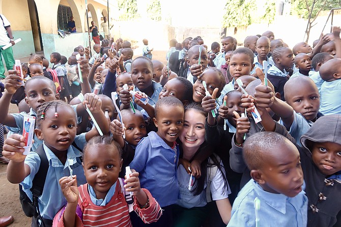 Katie Fairhurst of Potomac surrounded by children during her trip in Kenya.