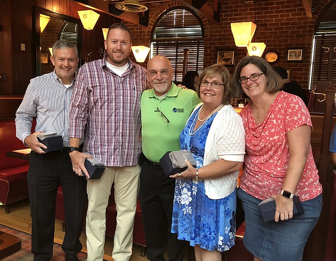 WiSC Enterprises founder and president Bill Craig, center, poses with some of his employees Aug. 21 at the 10th anniversary celebration of the founding of the company. The Chantilly-based company was recently named the recipient of the 2018 Public Sector Pro Patria Award, the highest award given to a civilian employer by the Virginia Employer Support of the Guard and Reserve Committee. With Craig at Mike’s American Grill are: Greg Creech, Mark Mogle, Betty Musa and Cary McConnell.