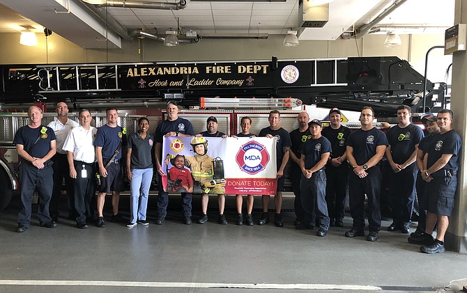 Alexandria Fire Chief Robert Dube, third from left, joins firefighters and paramedics Aug. 28 at Station 209 in Potomac Yard to kick off the annual Fill the Boot campaign to raise funds for the Muscular Dystrophy Association.