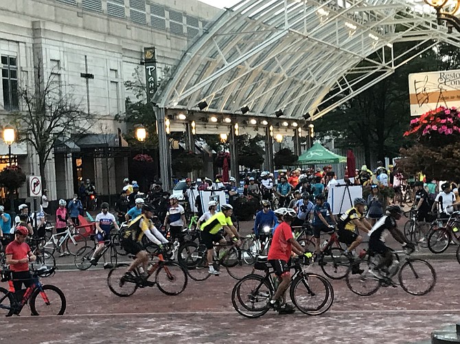 Registered cyclists for the 35th Annual RBC Century await the 6:30 a.m. start call under the lights of the Reston Town Center Pavilion on Sunday, August 26.
