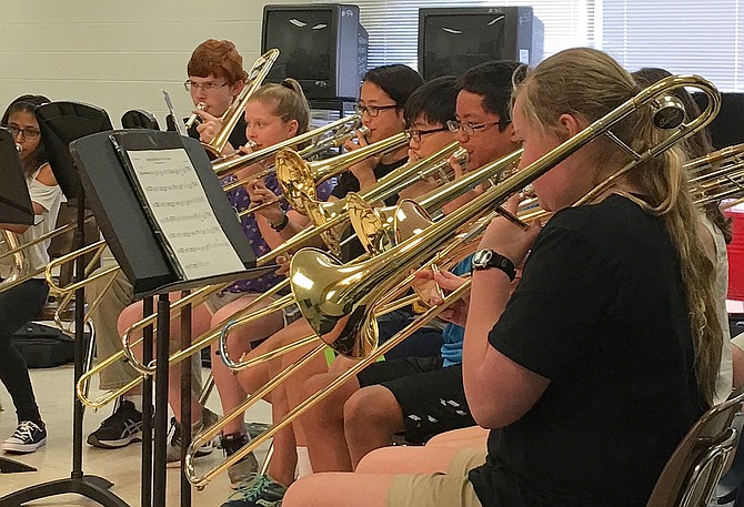 Trombone players from the concert and symphonic bands performing together.