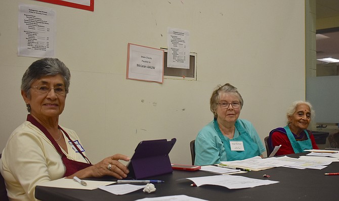 Amalia Iglesias, Ginger MacEwen and Raji Brahmam volunteer at the sale.