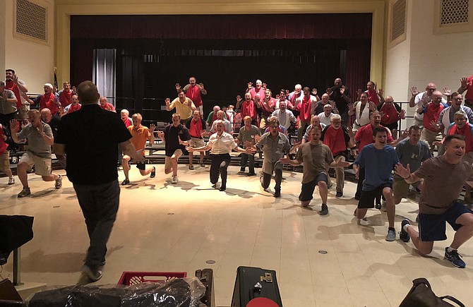 With Joe Cerutti directing, left foreground, The Alexandria Harmonizers rehearse Sept. 4 at the Scottish Rite in preparation for the 70th Anniversary concert Sept. 8 at the Rachel Schlesinger Concert Hall. The internationally acclaimed men’s barbershop chorus will be joined by the Toronto Northern Lights Chorus and Florida’s Signature Quartet.