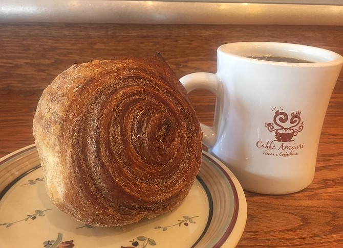 Combination of a heated cinnamon roll and cup of their coffee starts the day.