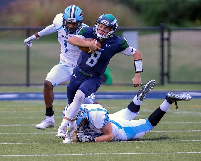 South County QB Matthew Dzierski #8 avoids being brought down by Centreville's Joey Purvis #52.