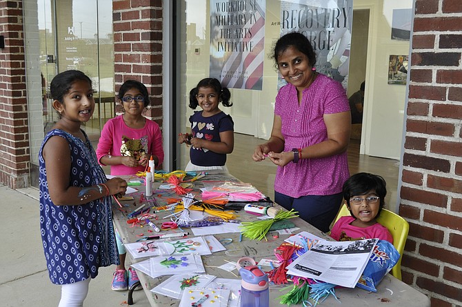 Children do a crafts project during the 10th Anniversary of the Workhouse Arts Center last weekend.