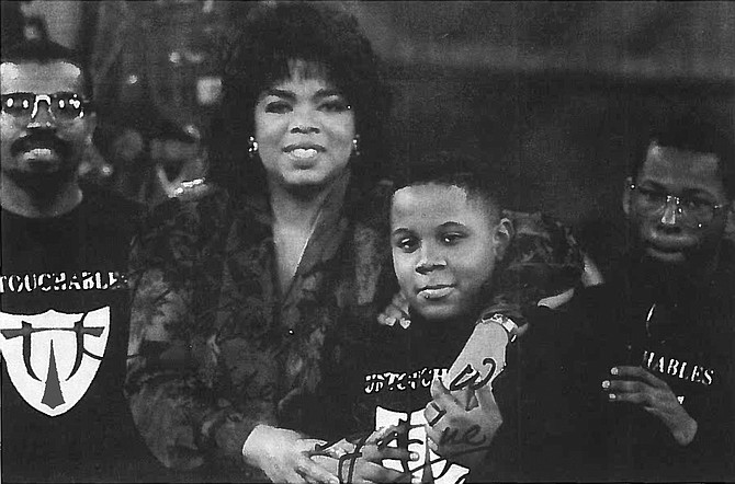 Oprah Winfrey with Ronnie Haskins, one of three young boys who sparked the idea behind the Untouchables mentoring program, which was honored by Winfrey in 1991. Haskins is now studying for his doctorate.