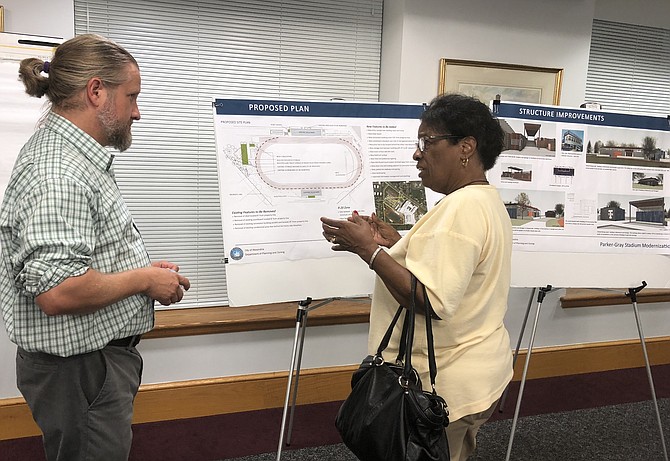 Seminary Civic Association president Frances Terrell, right, questions principal city planner Nathan Imm about the proposed plans to renovate Parker-Gray Memorial Stadium at T.C. Williams High School at the project’s Sept. 5 open house at City House. The plans include the addition of lights to allow for night time games and events.