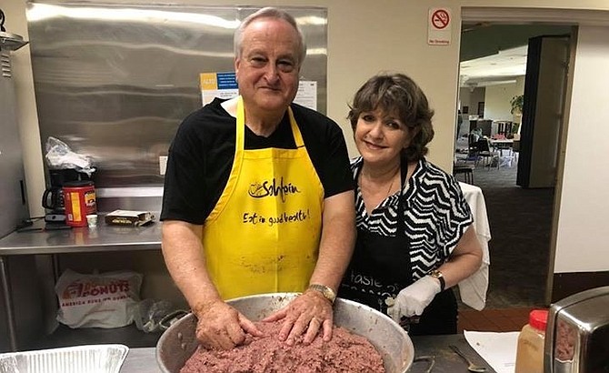 Michael and Nadia El-Hage prepare meat for the grape leaf stuffing.