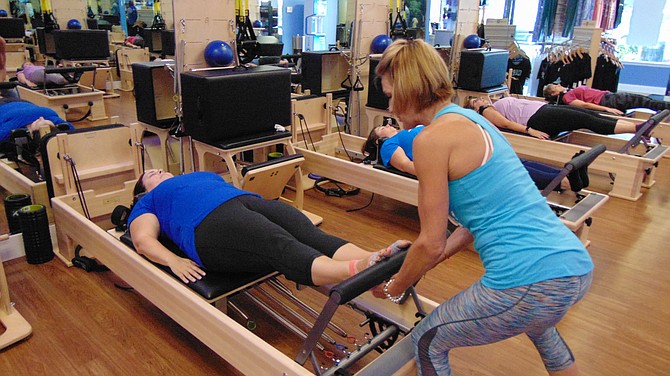 Lead Pilates instructor Rebecca Ceccin teaches footwork on the Reformer.