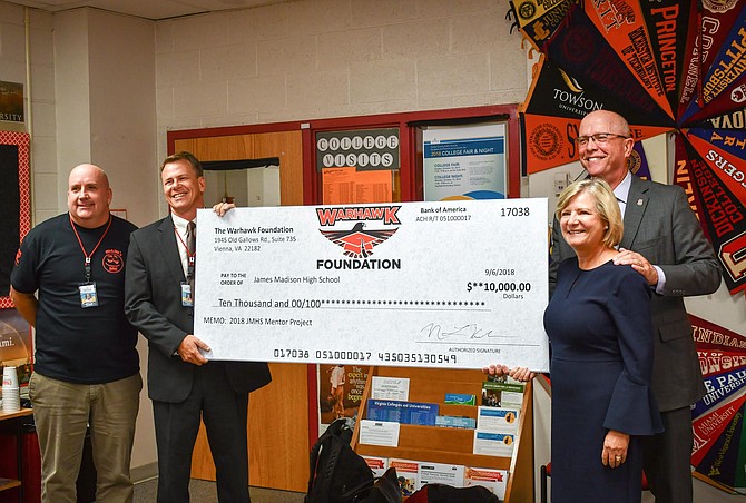 Tim Buckley, Director of Student Services at James Madison High School; Greg Hood, Principal at James Madison High School; Nathan and Gail Hibler, members of The Warhawk Foundation Board.