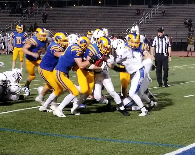 Robinson running back Tanner LaPlante fights his way into the end zone for a 9-yard touchdown against T.C. Williams on Sept. 13.