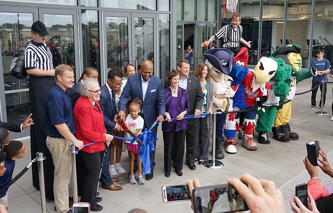 The St. James co-founders Kendrick Ashton and Craig Dixon, with scissors, are joined by local and state politicians Sept. 15 for the official ribbon cutting grand opening of The St. James sports and wellness complex in Springfield.