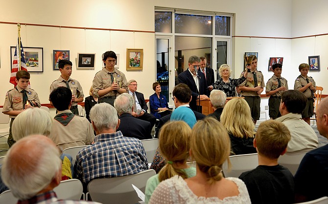 A candle held and a bell rung for each of the six Great Falls residents who died on 9/11.