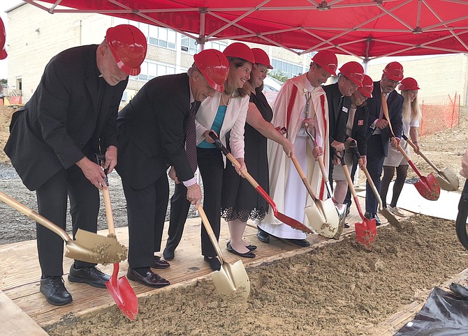 Bishop Michael Burbidge, center, leads local and school dignitaries in breaking ground Sept. 18 for the new 40,000-square-foot academic center at Bishop Ireton High School.