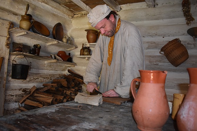 Philip Hosea, a historical reenactor at Claude Moore Colonial Farm. works on the farm, going through the actions that a colonial tenant farmer in 1771 would have done.