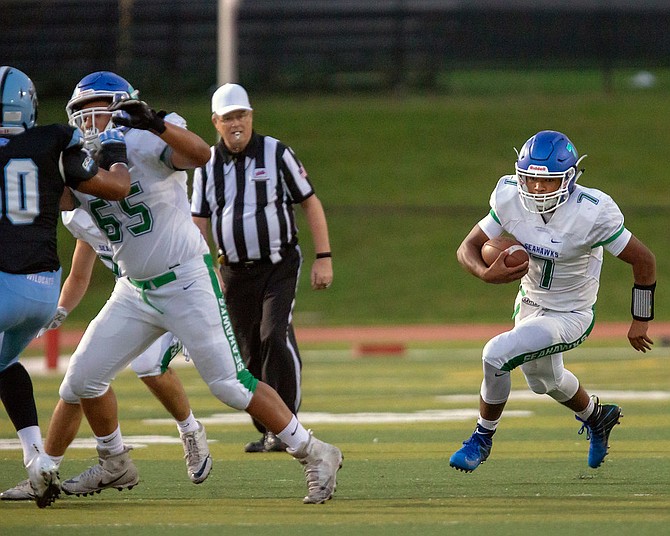 Marcus Miles #7 carries the ball for South Lakes.
