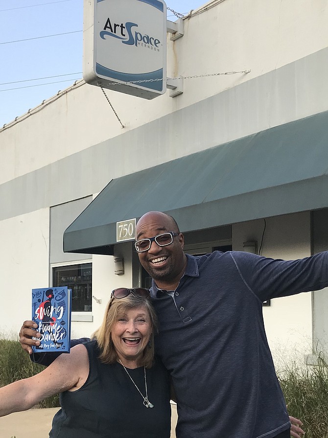 Newbery Medalist and Herndon resident, Kwame Alexander, author of the New York Times Bestseller, "Rebound,” holds a copy of his and Mary Rand Hess' new book, "Swing” after he and Jo Ormesher, CEO and President of Arts Herndon prepared for Arts Herndon’s inaugural “Children's Literary Festival."  The event will be on Sunday, Oct. 7, 2018, 11 a.m. to 4 p.m. at ArtSpace Herndon, 750 Center Street in Historic Downtown Herndon.